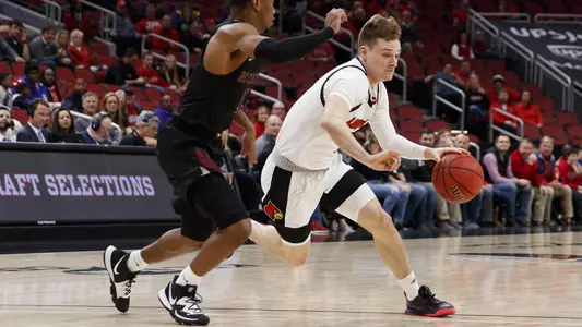 Keith Oddo dribbles around an NC Central player in the KFC Yum! Center.