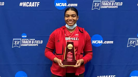 Makenli Forrest with the NCAA Weight Throw Trophy