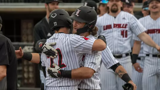Ben Bianco and Ben Metzinger hug after a home run against Akron.
