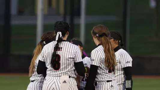Softball team huddle against North Carolina