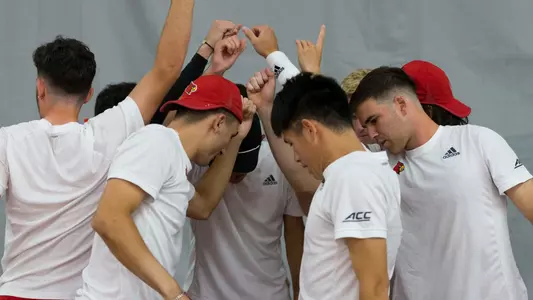 Men's Tennis breaks a huddle 