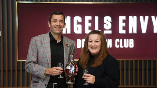 Josh Heird & Gigi DaDan toast the opening of the Angel's Envy Bourbon Club
