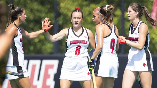 Louisville field hockey celebrates after a goal
