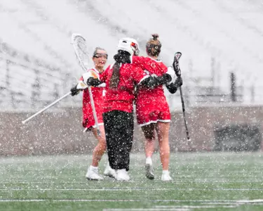 Sara Addeche, Maggie Foster, and Marley Scott celebrate against BC.