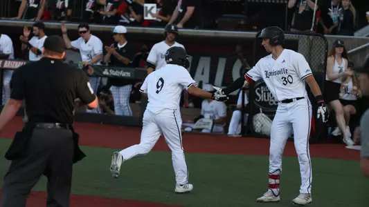 The Cardinals after scoring a run against Vanderbilt.