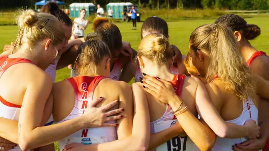 Women's cross country team huddles before the start of the ACC Championships.