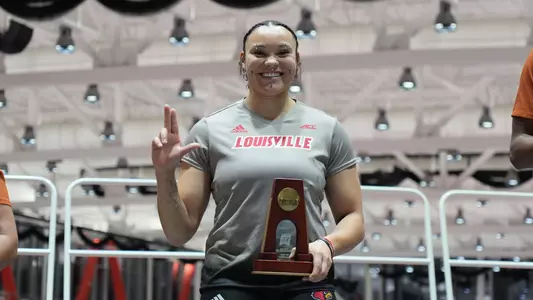 Jayden Ulrich poses with her sixth-place trophy after earning First Team All-American honors in the women's shot put at the NCAA Indoor Championships.