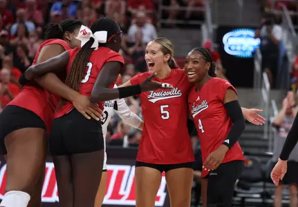 Charitie and Anna celebrate a point on the court against Tennessee 