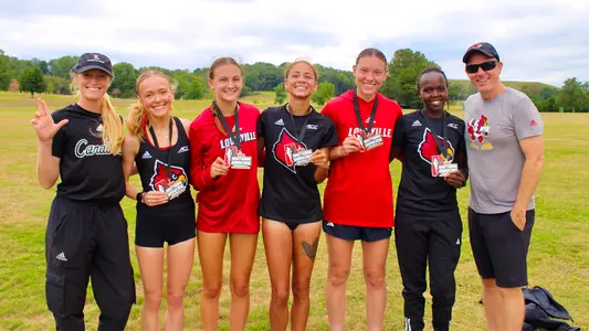 The women's cross country poses with their medals after a runner-up finish at the Southern Showcase.