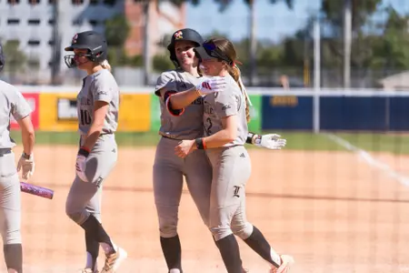 Jordan Williams and Madison Pickens hug after homerun against Texas A&M-Corpus Christi.