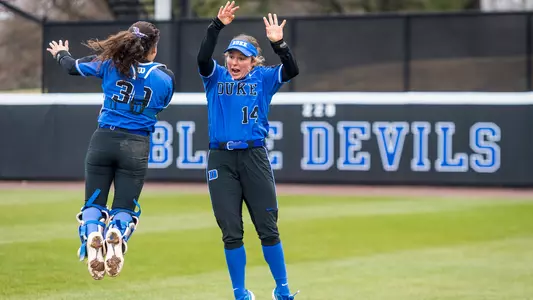 Raine Wilson and Jazz Moreno jumping in the outfield