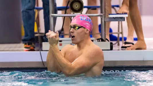 Nathaniel Hartley flashing the Bull City sign after an event