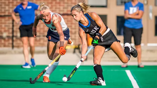 Senior midfielder Margaux Paolino pushes a ball past a Syracuse player in the teams' ACC opener