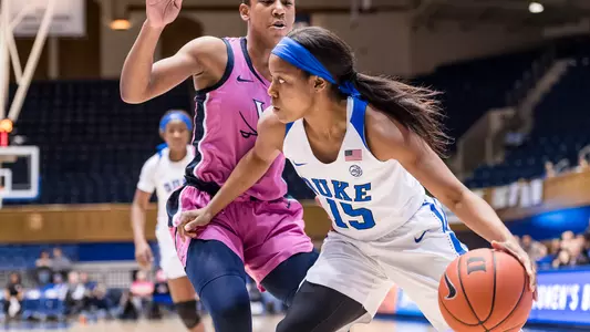 Kyra Lambert dribbling around a Virginia defender