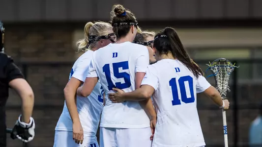 women's lax team huddle