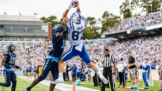 Noah Gray makes a catch over top a North Carolina defender during the two teams' contest in 2019