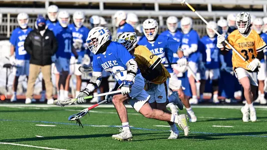 Jake Naso wins a faceoff at Towson.
