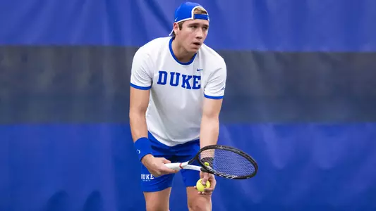 Edu Guell gets ready to serve against UNCW on Friday