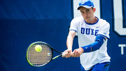 Andrew Dale focuses on hitting the ball during Duke's tennis match with Wake Forest