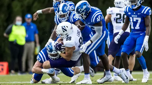 Ben Frye along with others along the defensive line take down a Northwestern player