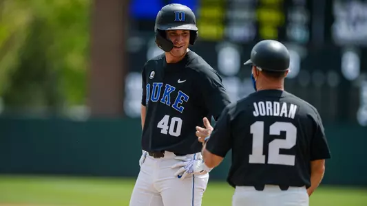 Duke assistant head coach Josh Jordan talks to junior outfielder RJ Schreck (40) in Boshamer Stadium in Chapel Hill, NC on April 11, 2021. The Tar Heels beat the Blue Devils 11-5.