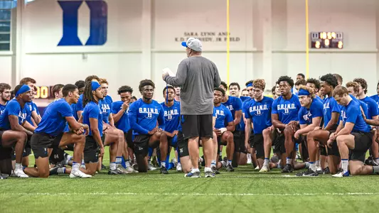 Head football coach Mike Elko speaks with the team prior to morning run