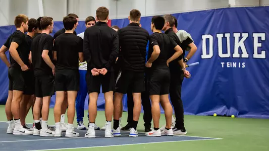 Duke men's tennis huddles as a team before competition with Kentucky