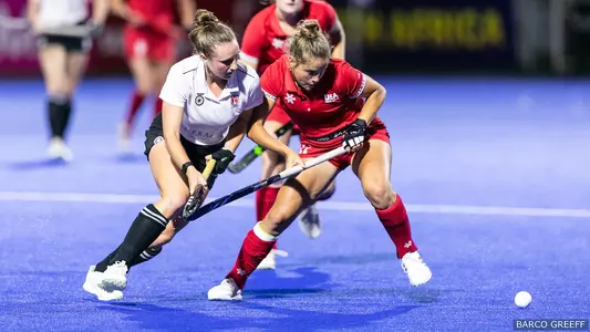 Josie Varney battles a player from Canada for the ball at the FIH Junior Women's World Cup