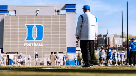 Head Coach Mike Elko watches the Blue Devils during spring practice