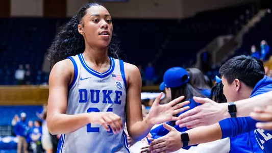 Reigan Richardson high fives Cameron Crazies following win over VT