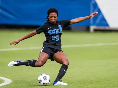 Mia Gyau kicks the ball during a 2020 Duke women's soccer game.