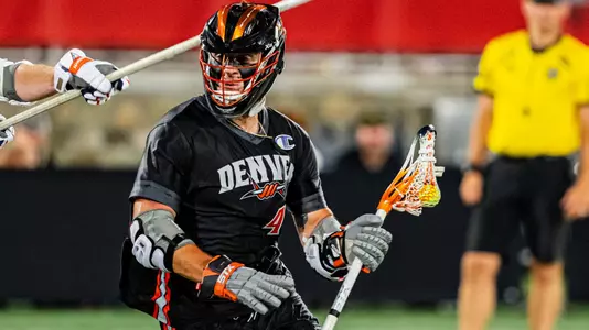 Brennan O'Neill of the Denver Outlaws dodges with stick in left hand