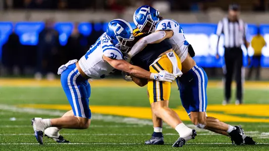 Duke linebackers Elliott Schaper and Luke Mergott combine on a tackle during Duke's 45-21 victory at Cal on October 4, 2025.