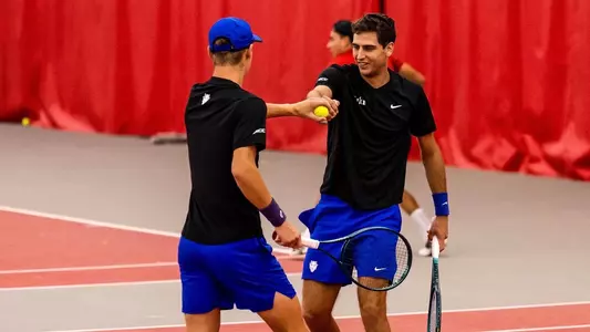 Duke men's tennis duo Pedro Rodenas and Cooper Williams exchange fist bumps following a point against No. 9 NC State.