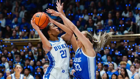 Arianna Roberson takes a contested layup against teammate Taylor Solfikanich in blue vs white scrimmage
