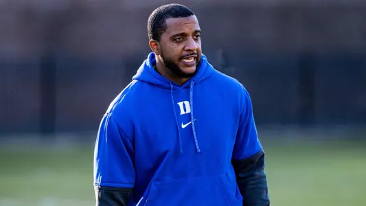 Duke running back coach Rodney Freeman II stands and watches a spring practice.