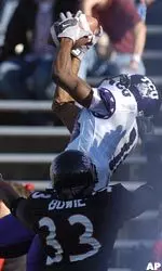 TCU wide reciever Quentily Harmon pulls in a 17-yard touchdown pass over Cincinnati cornerback John Bowie during the second quarter.