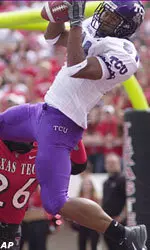 Texas Christian receiver Reggie Harrell (81) hauls in a touchdown pass against the defense of Texas Tech's Khalid Naziruddin (26) in the second quarter
