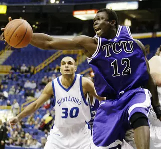 Femi Ibikunle of Nigeria yells as he reaches for a loose basketball in front of Saint Louis' Izik Ohanon.