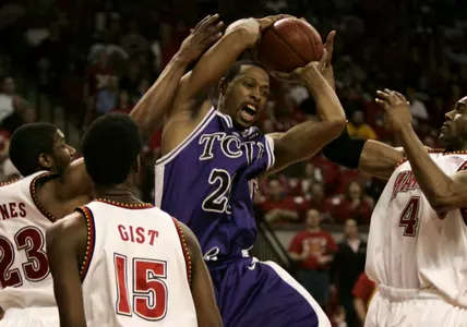 TCU's Aaron Curtis, center, rips a rebound away form Maryland. (AP Photo/Chris Gardner)