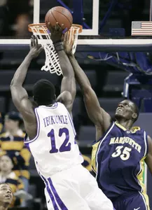 Femi Ibikunle of TCU shoots over the reach of Marquette's Marcus Jackson in the first half at the CUSA tournament. (AP Photo/Mark Humphrey)