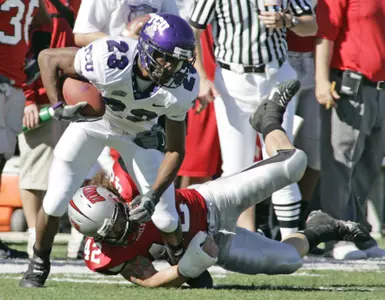 Aaron Brown fights off a UNLV defender's tackle in the first quarter. (AP Photo)