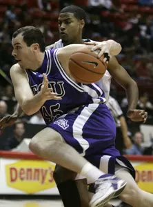 TCU's Art Pierce drives past San Diego State's Mohamed Abukar while going for the basket. (AP Photo/Lenny Ignelzi)