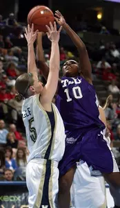 Moneka Knight, right, goes up for a shot over  BYU guard Jennie Keele in the first half.