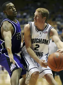 Blake Adams defends against BYU's Mike Rose during a basketball game. (AP Photo/The Daily Herald, Cobb Condie)