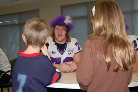 Eleven TCU football players, including freshman center Jake Kirkpatrick, spent part of their bowl trip at Houston's DePelchin Children's Center.