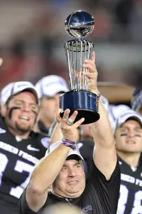 TCU football coach Gary Patterson hoisting the Rose Bowl Championship Trophy.