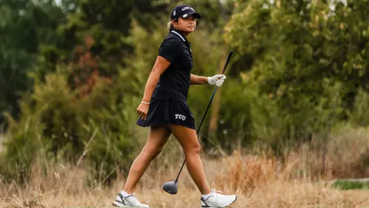 Kirstin Angosta departs the tee box holding her driver shaft as she tracks her ball