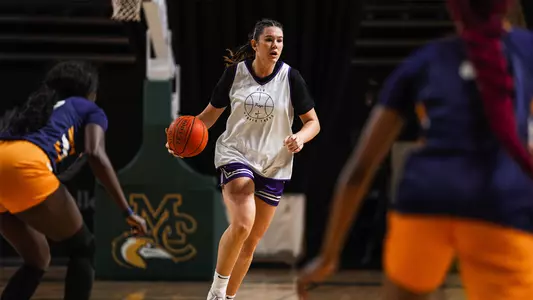 Lara Somfai dribbles in transition wearing a white practice jersey
