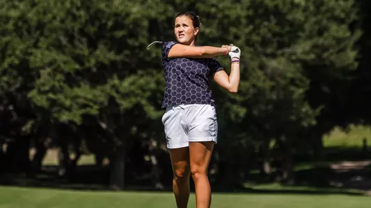 Ella Forss plays a second shot with an iron wearing a black shirt